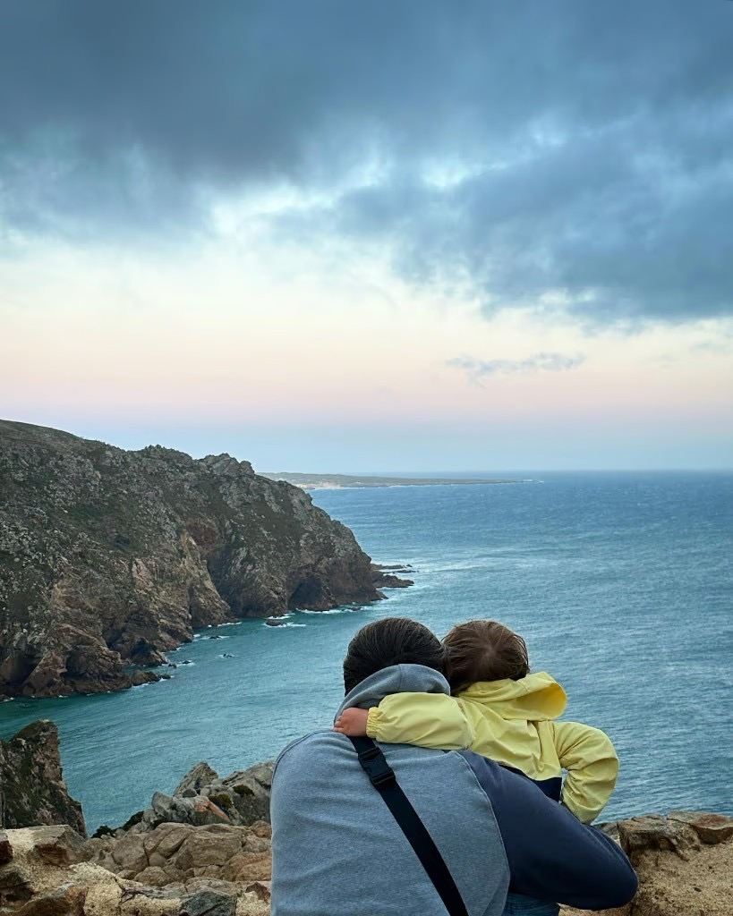 Alex and child overlooking the coast