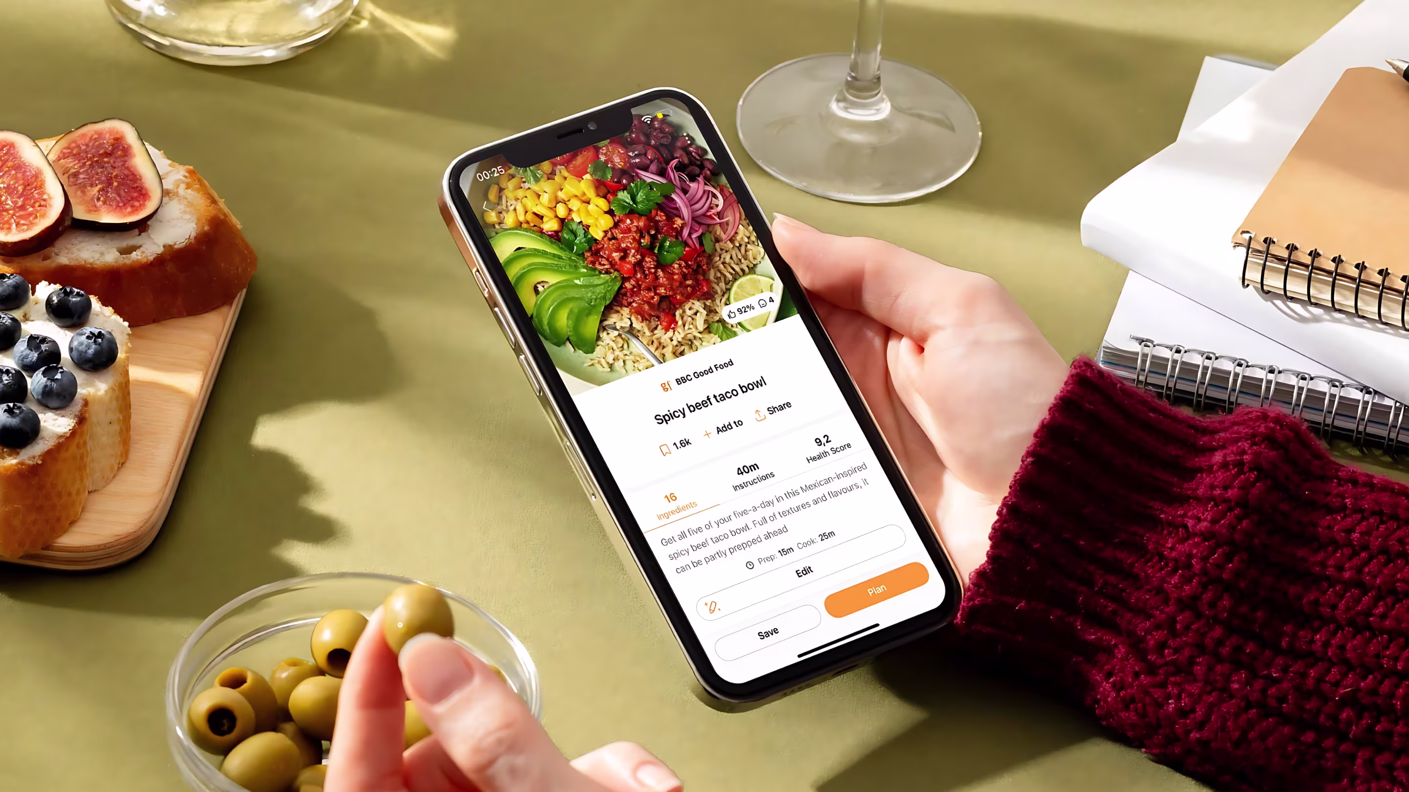 Samsung Food recipe on phone in a home kitchen setting