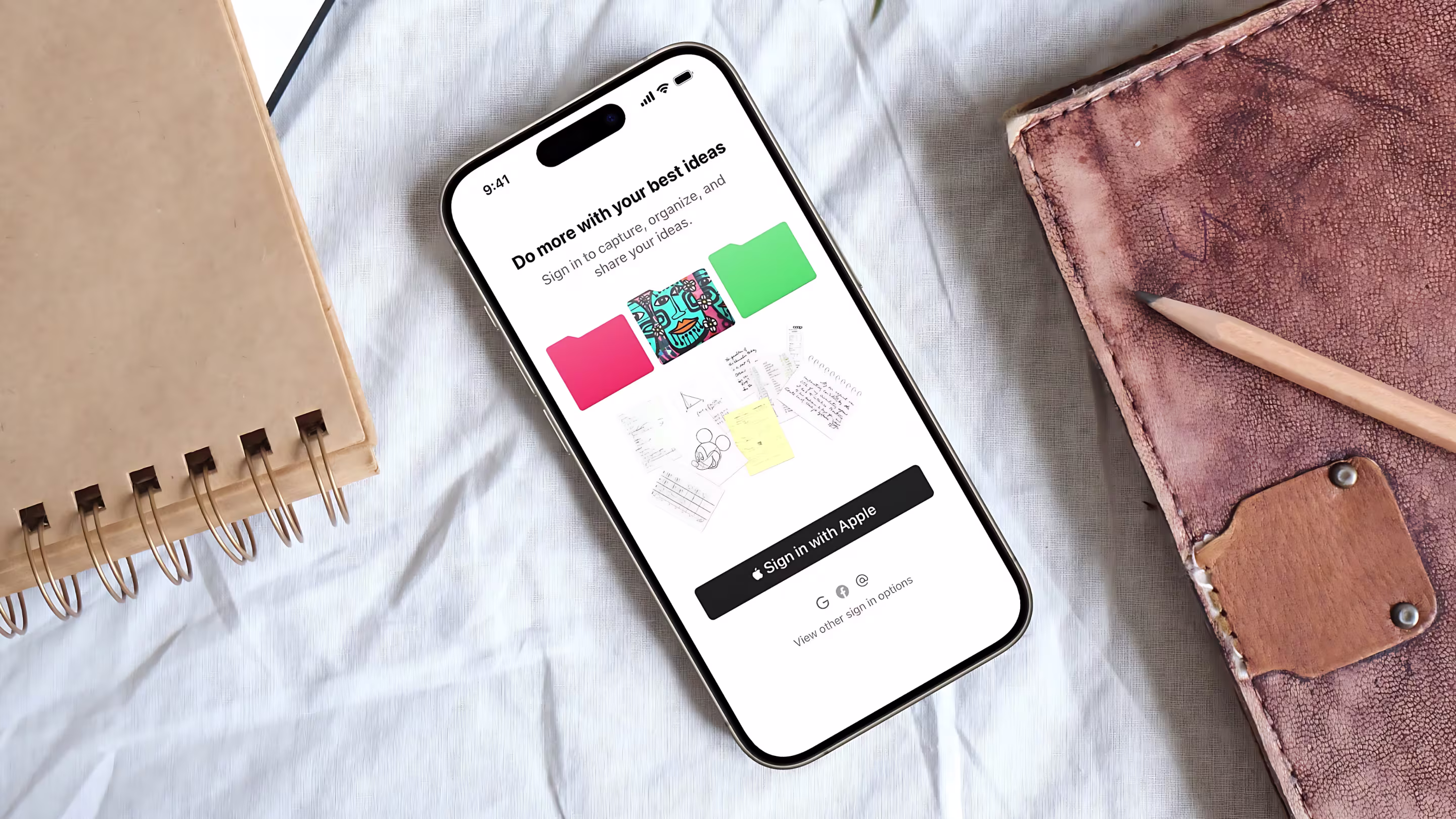 Thinkers sign-in screen on phone with notebooks